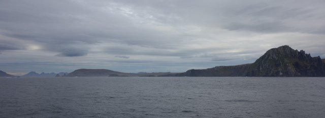 View of the rocky island landscape of Cape Horn, the tip of South America. As so often, cloudy but dry weather accompanied us today, enveloping the day in a colourless blue-grey. Nevertheless, Neptune was kind to us, only a light breeze made the sea drift gently up and down in calm waves, because the north side of the Drake Passage, which ends here, can also show quite different sides of itself, I speak from experience.
